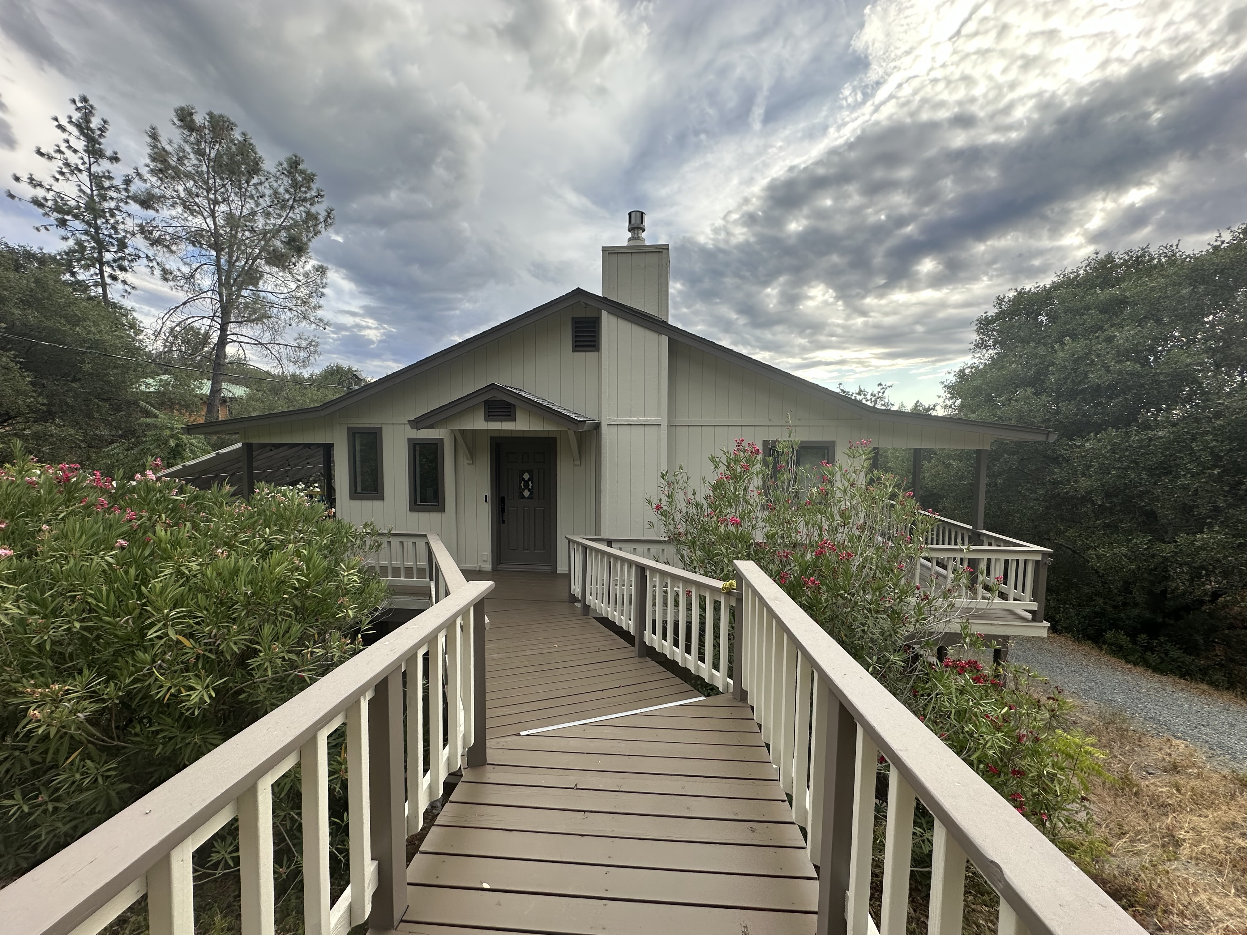 The front of the house with its flowering walkway