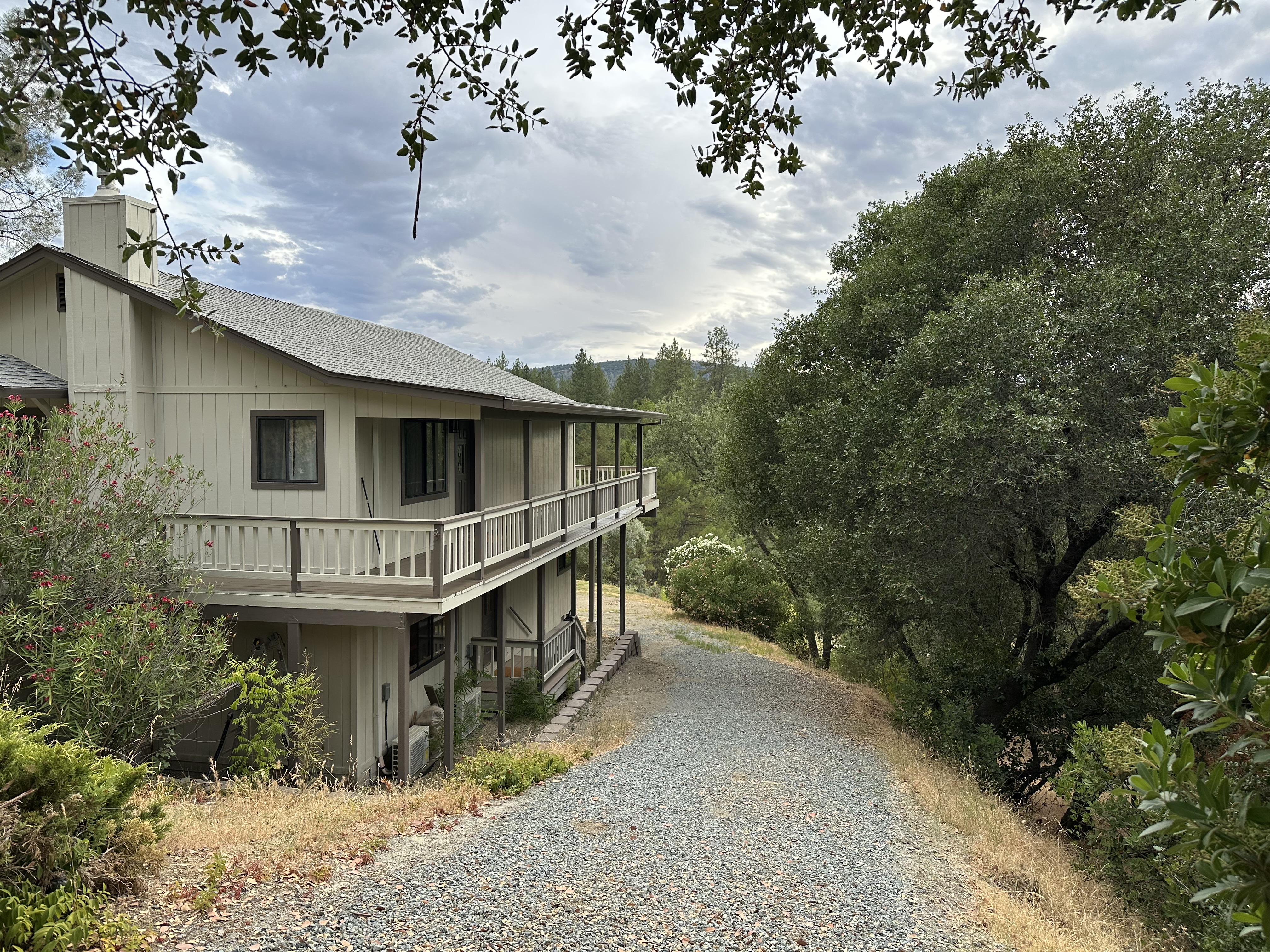 The river house with its wraparound deck above the valley