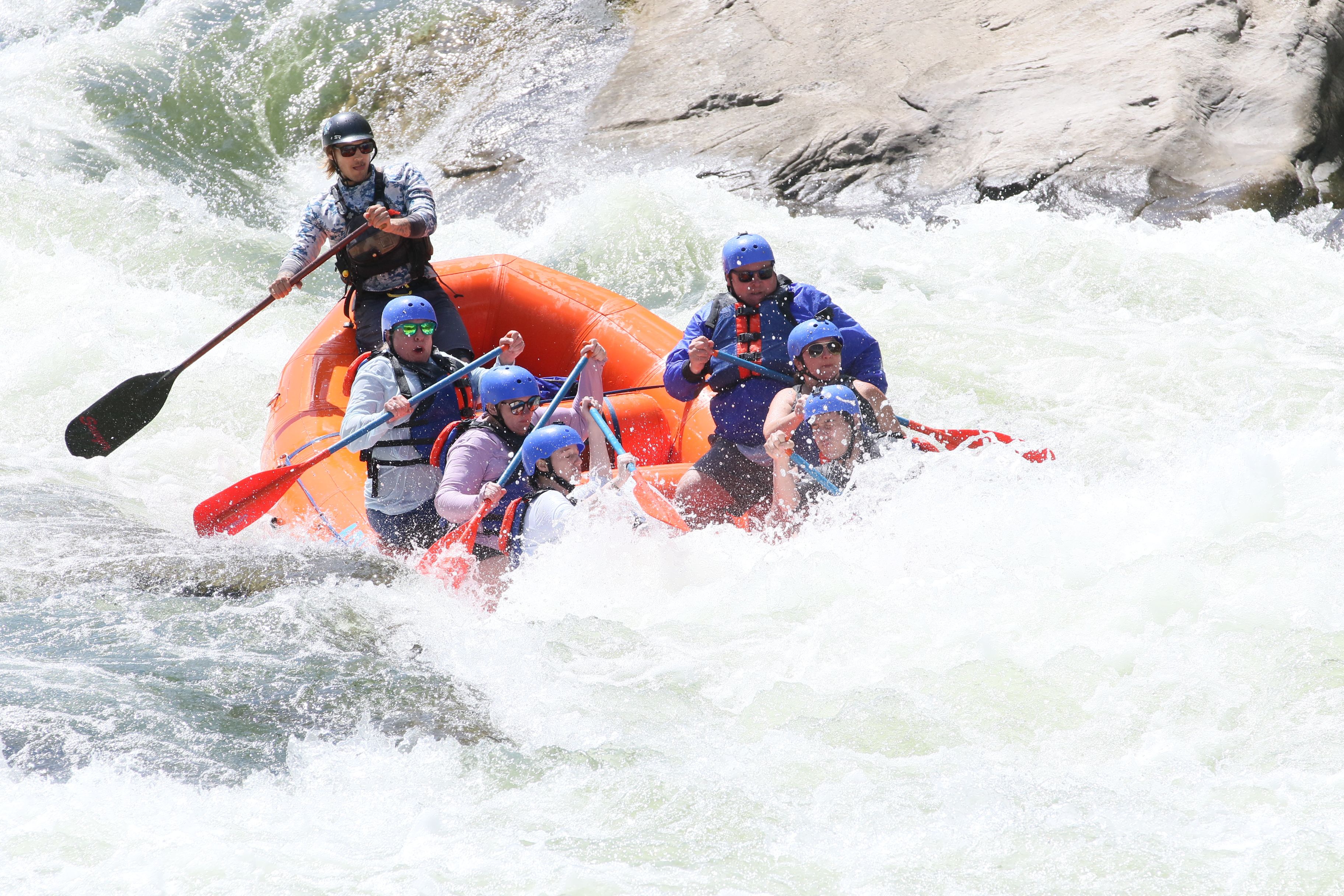 A paddle crew punching through whitewater rapids
